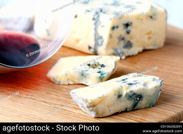 blue cheese on a wooden background with knife
