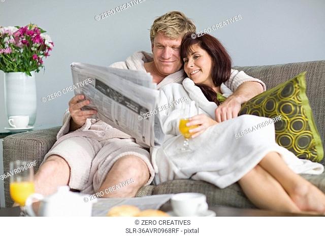 Couple in bathrobes having breakfast