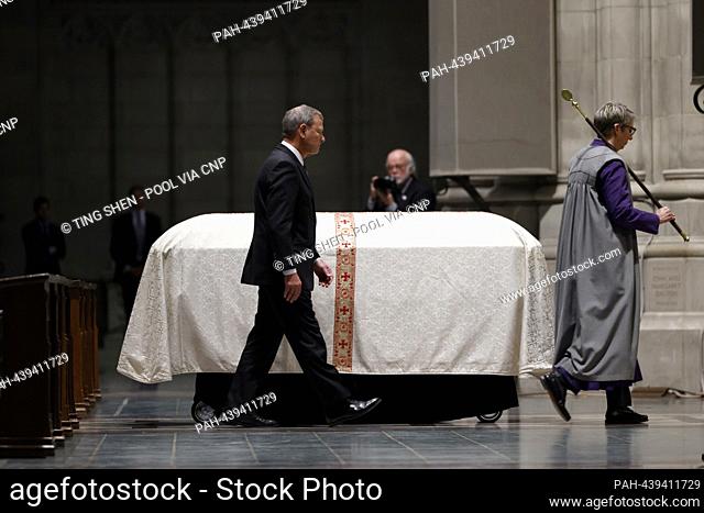 Chief Justice of the United States John G. Roberts, Jr., left, walks to speak at the funeral service of late Associate Justice of the Supreme Court Sandra Day...
