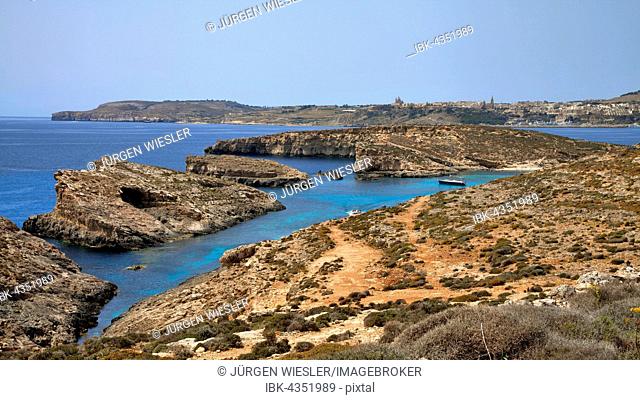 Yacht in Blue Lagoon, island of Gozo in background, Comino, Malta, Europe
