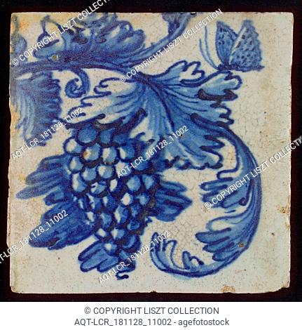 Tile with blue bunch of grapes, leaves and butterfly, tile picture footage fragment earth discovery ceramics earthenware glaze