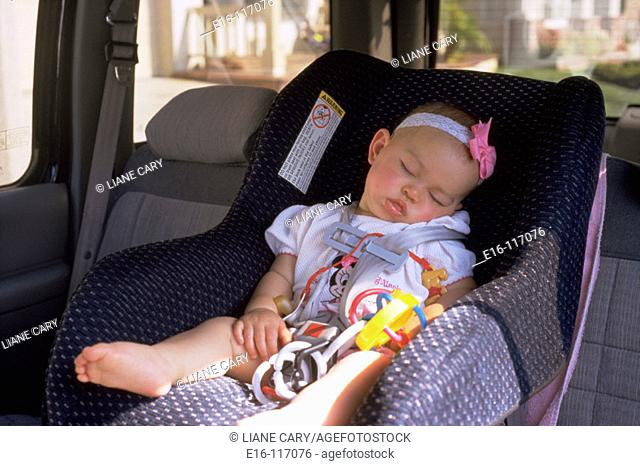 Young child asleep in car seat