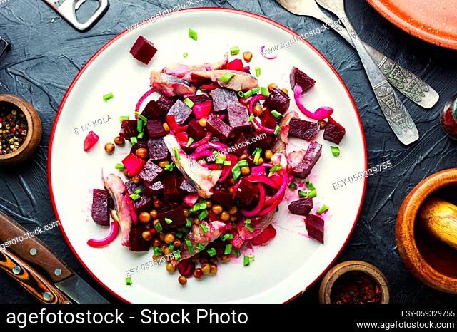 Salad with herring, beets, onions and green peas.Traditional russian salad