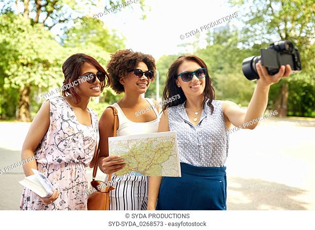 women with map travelling and recording video blog
