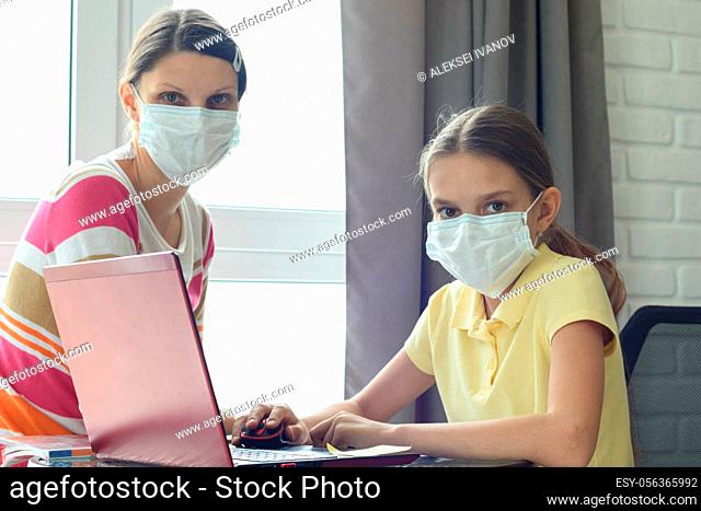 Quarantine mom and daughter do home lessons online