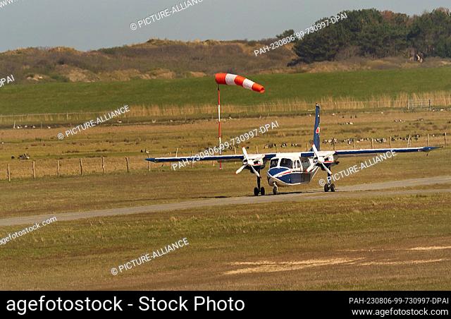 14 April 2023, Lower Saxony, Wangerooge: 14.04.2023, Wangerooge. A pilot of FLN Frisia-Luftverkehr GmbH with his Britten-Norman BN-2 Islander aircraft at the...