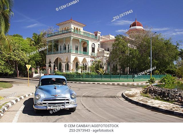 Old American car in front of the Palacio De Valle -Valle's Palace In Punta Gorda district, Cienfuegos, Cuba, West Indies, Central America