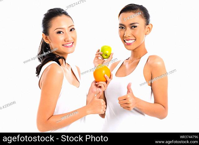 Asian friends eating fruit living healthy