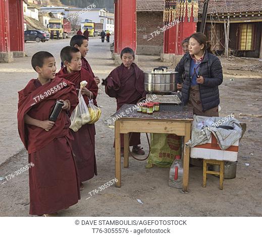Monks buying dumplings, Langmusi, Gansu, China