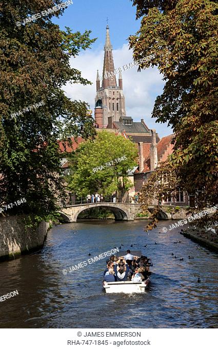 Bridge to Begijnhof, and spire of Church of Our Lady, tourist launch, Bruges, UNESCO World Heritage Site, Belgium, Europe