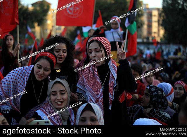 Palestinian supporters of the Popular Front for the Liberation of Palestine (PFLP) wear checkered 'kafiyeh' headdresses, as they celebrate at the Gaza city