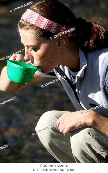 Woman drinking out of a cup