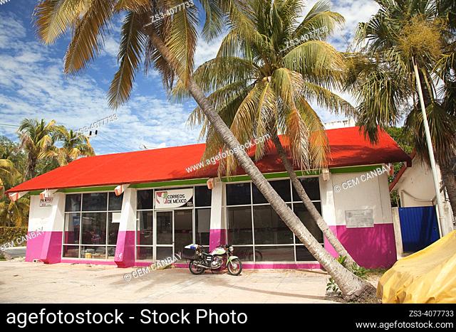 View of the colorful post office building under the palm trees at North Beach-Playa Norte, Isla Mujeres, Cancun, Quintana Roo, Mexico, Central America