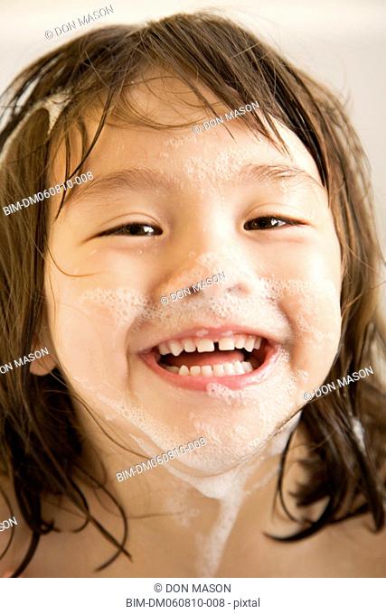 Asian girl with soap suds on face