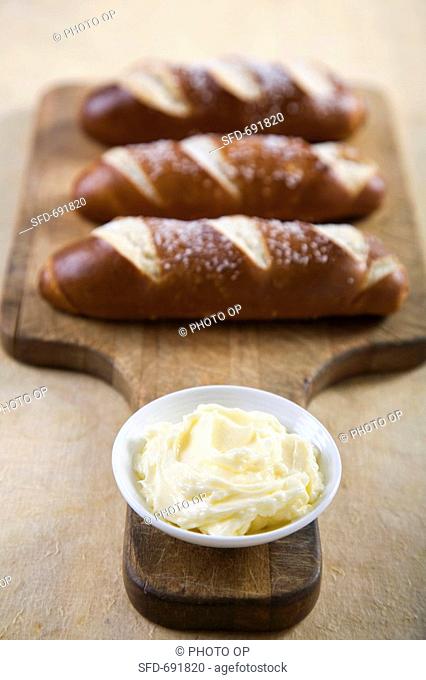 Small Bowl of Butter, Loaves of Pretzel Bread
