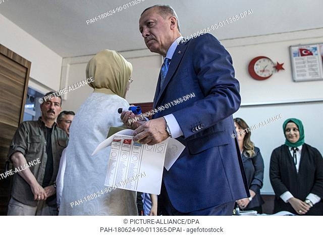 Turkish President Tayyip Recep Erdogan (R) and his wife Emine Erdogan at a polling station, in Istanbul, Turkey, 24 June 2018