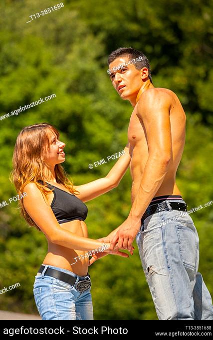Teenagers boy and girl in Summer in denim pants