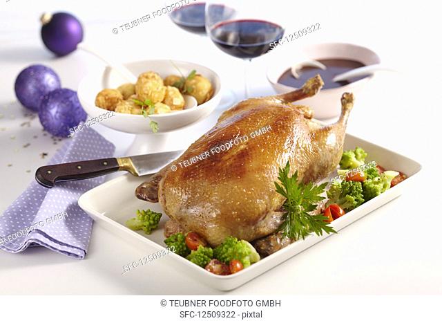 Roast duck with a minced meat stuffed, vegetables and potato and almond bites