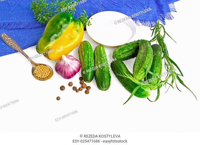 Cucumbers, sweet peppers, mustard seeds in a teaspoon, a pea sweet pepper, garlic, a sprig of tarragon, dill, umbrella, cup with salt and blue tissue paper...