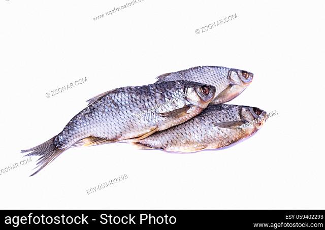 Three salted dried fish roach on a white background