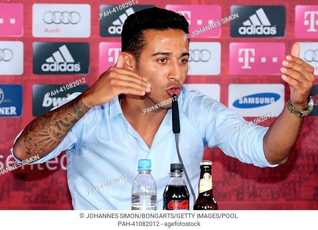 Munich's new player Thiago Alcantara gestures during his introduction as a new player during a press conference at Bayern Munich's headquarters on Saebener...