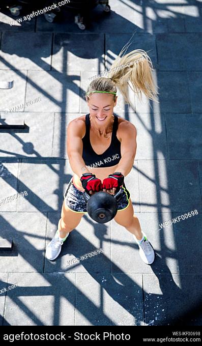 Woman exercising with kettlebell at rooftop gym