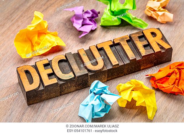declutter - abstract in vintage letterpress wood type blocks with crumpled sticky notes