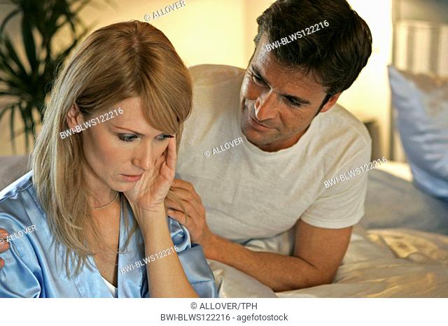 couple in bed, she suffers from migraine