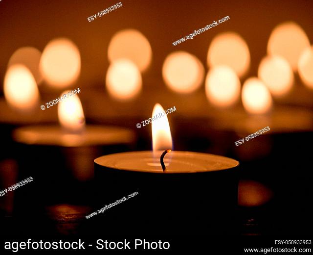 candle light on dark background with bokhe. Shallow DOF. Copy space
