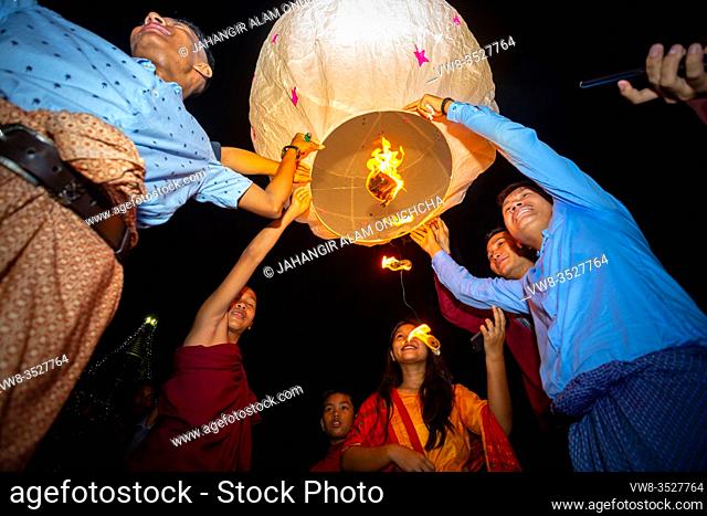 Bangladesh - October 13, 2019: Buddhist devotees family release sky lanterns to worship buddha's relics in Probarona Purnima festival at Bandarban, Bangladesh