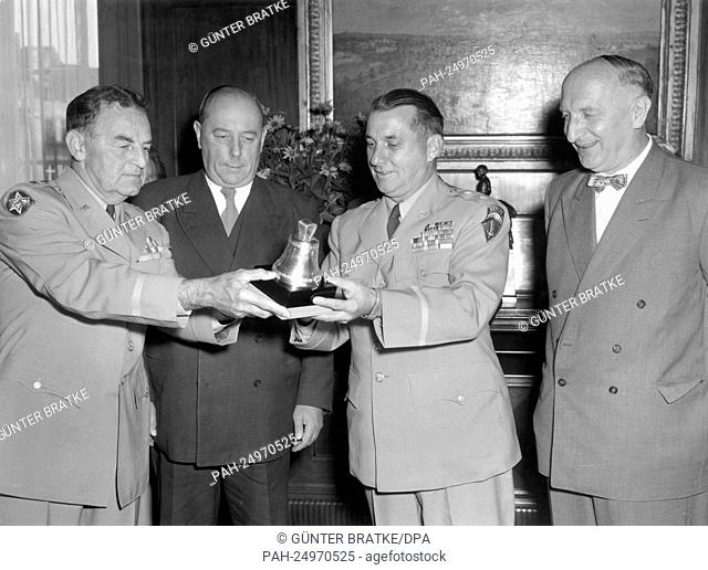 The parting American town major of Berlin General Thomas Timberman (l) receiving a silver replica of the Liberty Bell as a farewell gift on 30th July 1954 in...