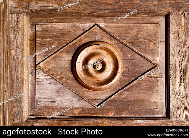 abstract rusty brass brown knocker in a  closed wood door solbiate arno varese italy