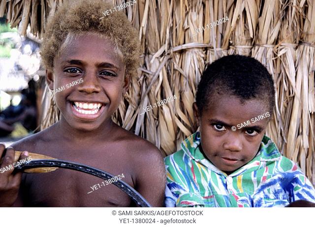 Portrait of two boys standing side by side, Sulphur Bay Village, Ipekel Ipeukel, Tanna Island, Vanuatu