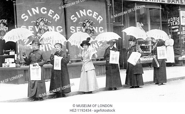 A parasol parade selling The Suffragette newspaper, Brighton, Sussex, April 1914. From left to right: Miss Reid, Mrs Goodier, Miss Gye, Mrs Brandon, Miss Rae