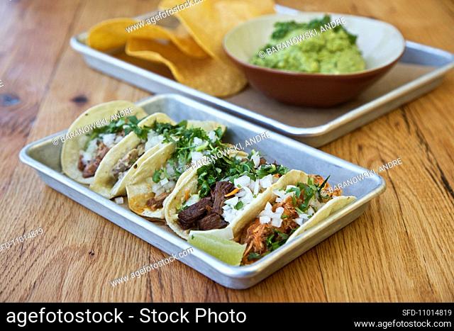 Various tacos with guacamole and tortilla chips (Mexico)