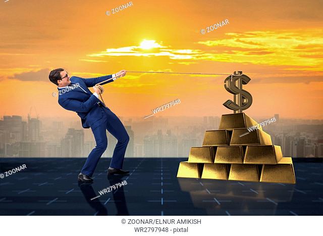 Businessman pulling dollar and gold bullions