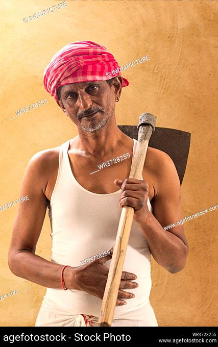 Portrait of a Farmer holding a Shovel