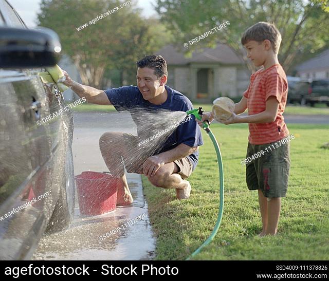 Father and son washing the car together