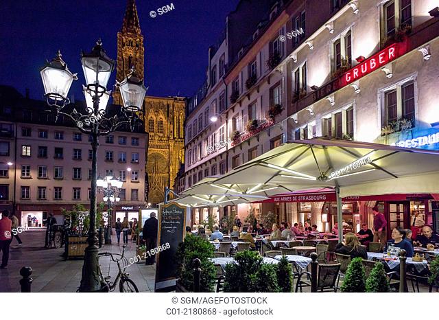 Gutenberg square with restaurant terraces and cathedral at night Strasbourg Alsace France