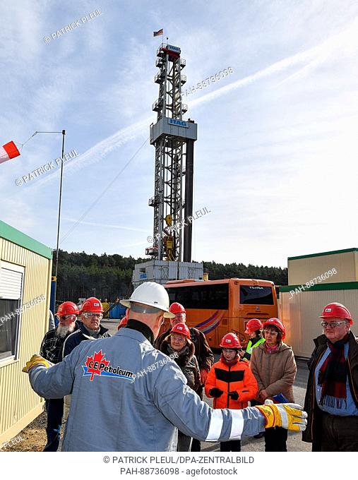 Drilling engineer Andre Beck explains the tower to visitors in front of an oil rig of the German-Canadian Central European Petroleum GmbH (CEP) near Krugau