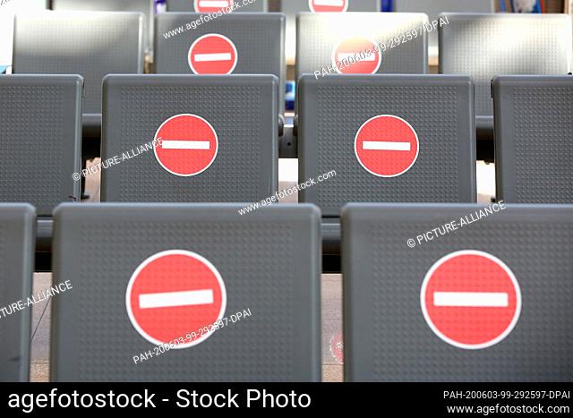 29 May 2020, Hamburg: Stickers for adhering to the distance rules are stuck on benches in the departure area in Terminal 1 at Hamburg Airport