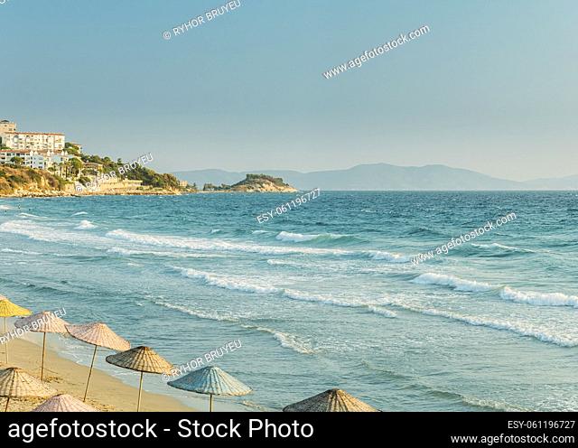 Umbrellas On Sea Beach. Vacation. Riplpe Sea Ocean Water Surface With Small Waves