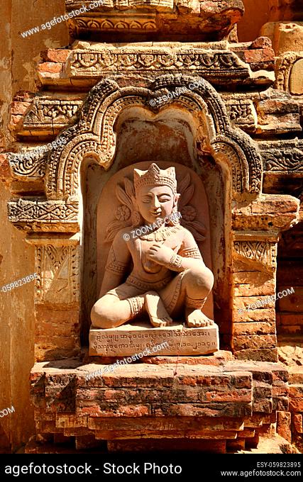 A small sculpture in a niche of the wall - a fragment of a pagoda in Bagan, Myanmar (Burma)