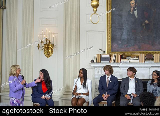 First lady Dr. Jill Biden, left, is joined by Ada Limón, 24th Poet Laureate of the United States, second from left, as she praises the poetry of the Class of...
