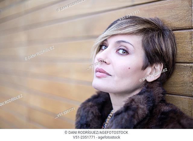 Portrait of a stylish woman outdoors looking at camera