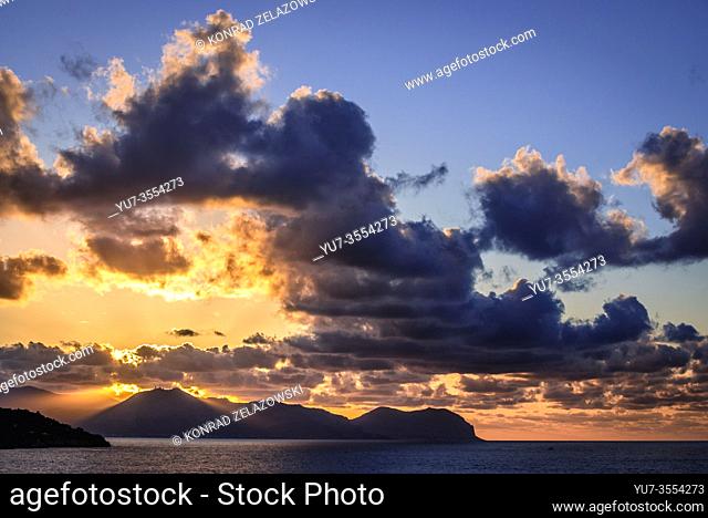 Sunset over Tyrrhenian Sea seen from Zafferano cape near Santa Flavia on Sicily Island in Italy, Gallo cape and Pellegrino mount on background
