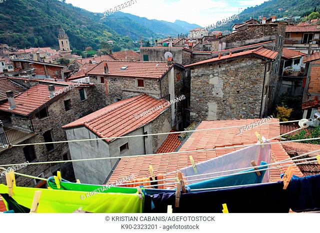 View out of a window with laundry in front and over the roof tops of other stone brick houses, Dolceacqua, Liguria, Italy, Europe
