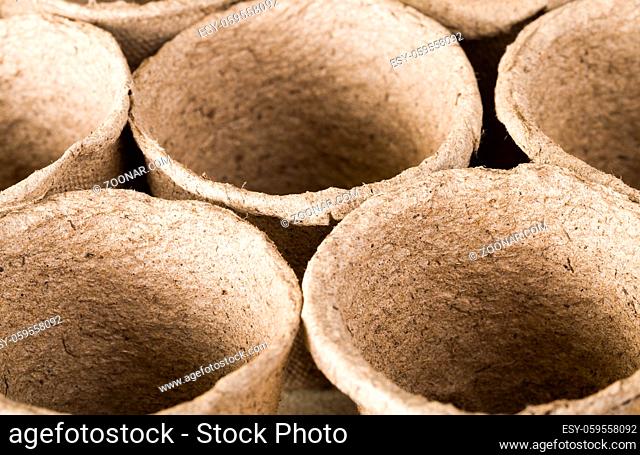 Small paper pots are made from cellulose and peat for growing seedlings and getting a big crop of crops
