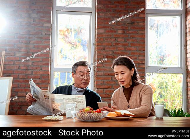 Elderly couple enjoy breakfast at home