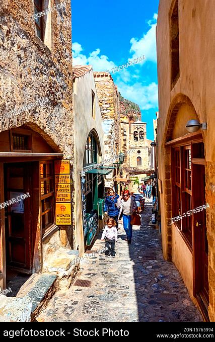 Monemvasia, Greece - March 31, 2019: Street view with old houses and greek restaurant tavern in ancient town, Peloponnese